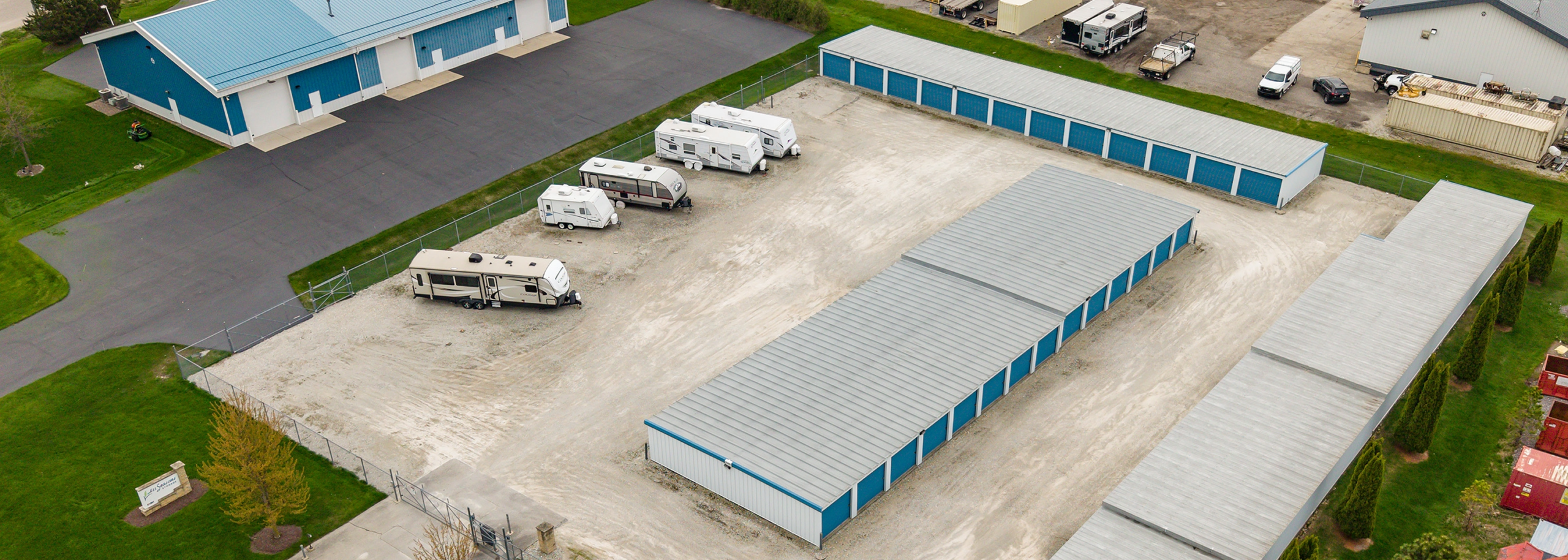 Cropped Air View Top-down aerial view of All Seasons Storage showing outdoor RV parking and full storage building layout in Franksville, WI
