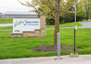 AllSeason_014 All Seasons Storage entrance sign with stone base and well-maintained grounds in Franksville, WI