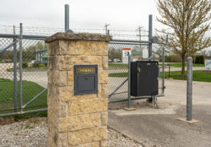 AllSeason_020 Gated entrance with keypad access and stone pillar at All Seasons Storage in Franksville, WI